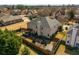 Aerial view of a home showcasing a backyard patio, manicured lawn, and surrounding neighborhood at 4215 Idlewood Dr, Cumming, GA 30040