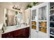 Bathroom featuring a shower, vanity, and built-in storage, combining convenience and design with a warm color scheme at 4215 Idlewood Dr, Cumming, GA 30040