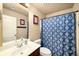 This bathroom features a shower-tub combination with blue shower curtain and a modern vanity at 4215 Idlewood Dr, Cumming, GA 30040