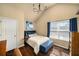 Well-lit bedroom with hardwood floors, a window with blinds, and blue accents at 4215 Idlewood Dr, Cumming, GA 30040