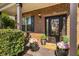 Inviting front porch adorned with potted flowers and a decorative wreath on the front door, enhancing curb appeal at 4215 Idlewood Dr, Cumming, GA 30040