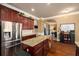 Modern kitchen featuring stainless steel appliances, granite countertops, cherry cabinets and island seating at 4215 Idlewood Dr, Cumming, GA 30040