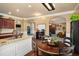 Spacious kitchen featuring granite countertops, dark wood cabinets, and an open layout connecting to the living areas at 4215 Idlewood Dr, Cumming, GA 30040