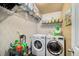 Laundry room with washer, dryer, and storage shelves at 4215 Idlewood Dr, Cumming, GA 30040