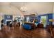 Open layout main bedroom features a fireplace, four-poster bed with a blue and yellow scheme and hardwood flooring at 4215 Idlewood Dr, Cumming, GA 30040