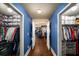 Dual walk-in closets leading into the main bedroom, offering ample storage and organization, with hardwood flooring at 4215 Idlewood Dr, Cumming, GA 30040