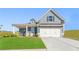 Charming single-Gathering home with blue siding, white garage door, and well-manicured lawn at 47 Colonial Ter, Villa Rica, GA 30180