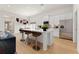 Modern kitchen with stainless steel appliances, white cabinets, an island, and three bar stools at 47 Colonial Ter, Villa Rica, GA 30180