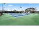 Well lit outdoor community tennis court with green and blue surface surrounded by trees at 47 Colonial Ter, Villa Rica, GA 30180