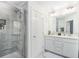 Modern bathroom with a double vanity, a marble tile shower, and sleek fixtures at 7652 Baron Rd, Fairburn, GA 30213