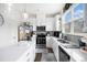 Bright kitchen with stainless steel appliances, quartz countertops, gray backsplash, and modern cabinets at 7652 Baron Rd, Fairburn, GA 30213