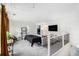 Living room with TV, staircase, and neutral color scheme, creating a cozy atmosphere at 7652 Baron Rd, Fairburn, GA 30213