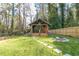 A charming backyard featuring a wooden pavilion and stone fire pit at 842 Laurelmont Sw Dr, Atlanta, GA 30311