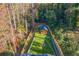 Aerial shot of backyard with new fence, yard, sitting area with a fire pit and wood cabin at 842 Laurelmont Sw Dr, Atlanta, GA 30311