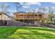 Backyard with a wooden deck, stone patio, manicured lawn, and retaining wall at 842 Laurelmont Sw Dr, Atlanta, GA 30311