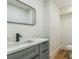 Stylish bathroom showcasing gray vanity with a black faucet, undermount sink, and modern rectangular mirror at 842 Laurelmont Sw Dr, Atlanta, GA 30311