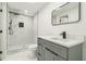 Modern bathroom featuring marble shower with rain shower head and gray vanity with quartz countertop at 842 Laurelmont Sw Dr, Atlanta, GA 30311