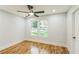 Bright bedroom with hardwood floors, a ceiling fan and views of the front yard at 842 Laurelmont Sw Dr, Atlanta, GA 30311