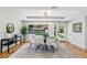 This dining room has a modern light fixture, tray ceiling, hardwood floors, and a large window overlooking the yard at 842 Laurelmont Sw Dr, Atlanta, GA 30311