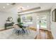 Dining room features a modern light fixture, a tray ceiling, and a beautiful large window with natural light at 842 Laurelmont Sw Dr, Atlanta, GA 30311