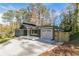 Traditional home exterior with garage, long driveway and lush lawn at 842 Laurelmont Sw Dr, Atlanta, GA 30311