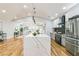 Well-lit, modern kitchen featuring a large island with a waterfall countertop and stainless steel appliances at 842 Laurelmont Sw Dr, Atlanta, GA 30311