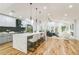 Open-concept kitchen featuring a large island with seating and pendant lighting next to a cozy living room at 842 Laurelmont Sw Dr, Atlanta, GA 30311