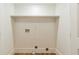 Empty laundry room with hardwood floors and built-in shelf for storage and convenience at 842 Laurelmont Sw Dr, Atlanta, GA 30311