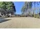 Spacious backyard with a well-maintained lawn and a volleyball net perfect for outdoor activities at 10683 Glenleigh Dr, Johns Creek, GA 30097