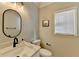 Stylish half bath with marble countertop, modern fixtures, and natural light at 10683 Glenleigh Dr, Johns Creek, GA 30097