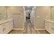 Hallway to bathroom with a light paint, tile floor and marble countertops at 10683 Glenleigh Dr, Johns Creek, GA 30097