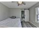 This bedroom features stylish barn door entry to bath, ceiling fan, and durable hardwood flooring at 10683 Glenleigh Dr, Johns Creek, GA 30097