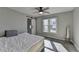 Cozy bedroom with a barn door to the bathroom, big window, and hardwood floor at 10683 Glenleigh Dr, Johns Creek, GA 30097