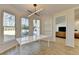 Bright breakfast nook with modern light fixture and view to the backyard at 10683 Glenleigh Dr, Johns Creek, GA 30097
