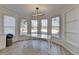 Bright breakfast nook with many windows and modern light fixture at 10683 Glenleigh Dr, Johns Creek, GA 30097