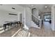 Spacious dining room with contemporary lighting, adjacent to stairs, and views of the home's interior at 10683 Glenleigh Dr, Johns Creek, GA 30097