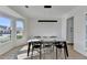 Light-filled dining area with modern light fixture and bay window with backyard views at 10683 Glenleigh Dr, Johns Creek, GA 30097
