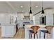 Modern kitchen with white cabinets, stainless steel appliances, and a spacious island with seating at 10683 Glenleigh Dr, Johns Creek, GA 30097