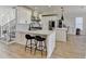 Bright kitchen features white cabinets, stainless steel appliances, and a large center island at 10683 Glenleigh Dr, Johns Creek, GA 30097