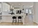 Bright kitchen features white cabinets, stainless steel appliances, and a large center island at 10683 Glenleigh Dr, Johns Creek, GA 30097