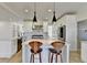Modern kitchen with white cabinets, stainless steel appliances, and a spacious island with seating at 10683 Glenleigh Dr, Johns Creek, GA 30097