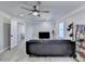 Living room with hardwood flooring and large black couch at 10683 Glenleigh Dr, Johns Creek, GA 30097