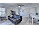 Spacious living room featuring a large black couch, desk and hardwood flooring at 10683 Glenleigh Dr, Johns Creek, GA 30097
