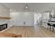 Open-concept living room with fireplace, wood floors, and staircase to the second floor at 10683 Glenleigh Dr, Johns Creek, GA 30097