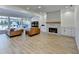 Spacious living room features a fireplace, modern lighting, and hardwood floors at 10683 Glenleigh Dr, Johns Creek, GA 30097