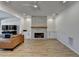 Cozy living room with stone fireplace, built-in cabinets, and wood floors at 10683 Glenleigh Dr, Johns Creek, GA 30097