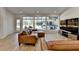 Bright living room featuring wood floors and a large window with backyard views at 10683 Glenleigh Dr, Johns Creek, GA 30097