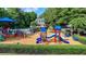 Aerial view of a colorful playground with slides and climbing equipment next to the pool and clubhouse at 10683 Glenleigh Dr, Johns Creek, GA 30097