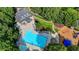 Aerial view of a sparkling blue pool and playground surrounded by lush greenery and mature trees at 10683 Glenleigh Dr, Johns Creek, GA 30097