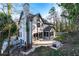 A large backyard patio is surrounded by mature trees, brickwork, a lush lawn, and a white picket fence at 160 Deer Cliff Cv, Lawrenceville, GA 30043